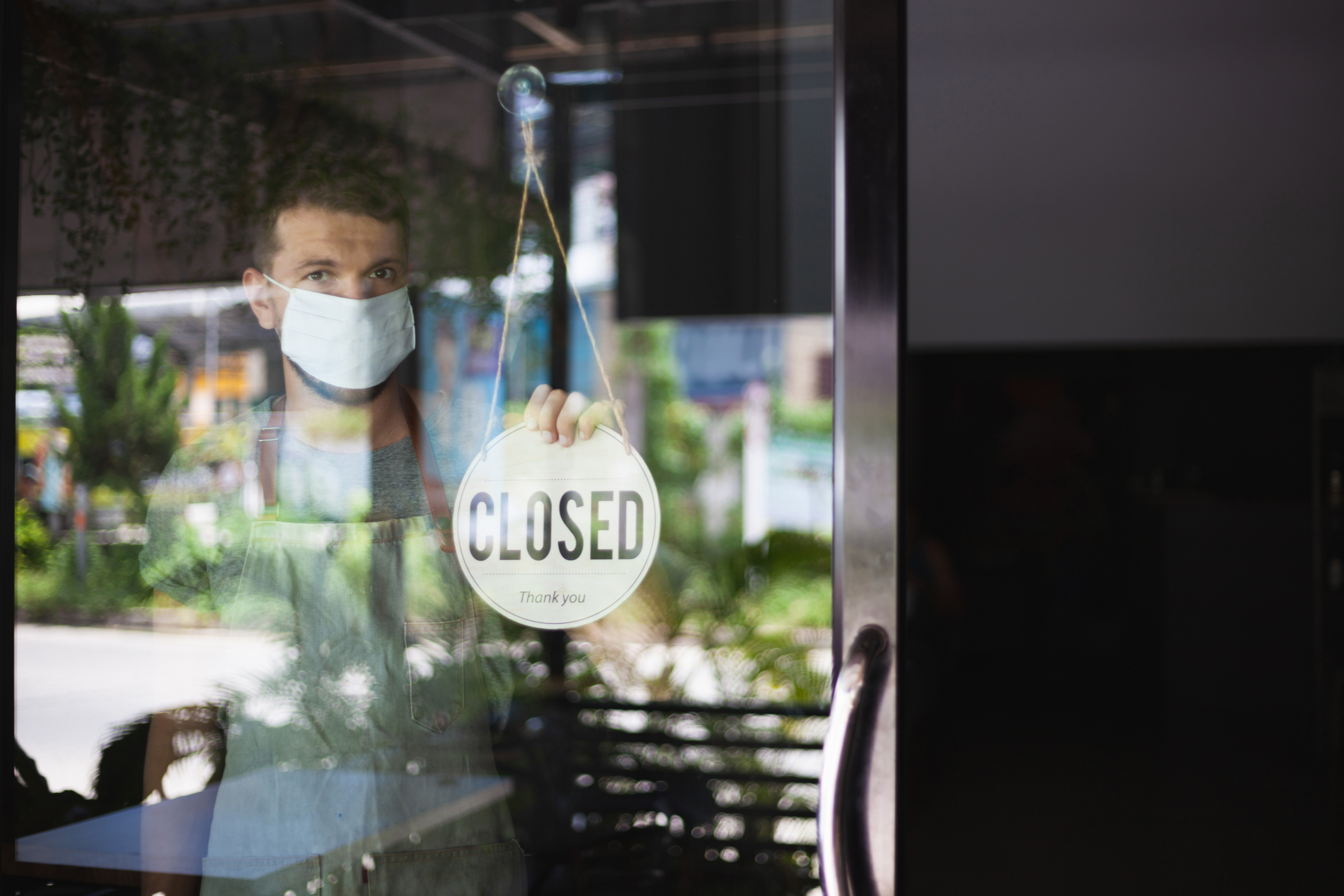 A man closes his business due to the COVID-19 pandemic.