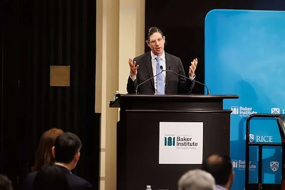 Jeremy Robbins speaks to audience from podium