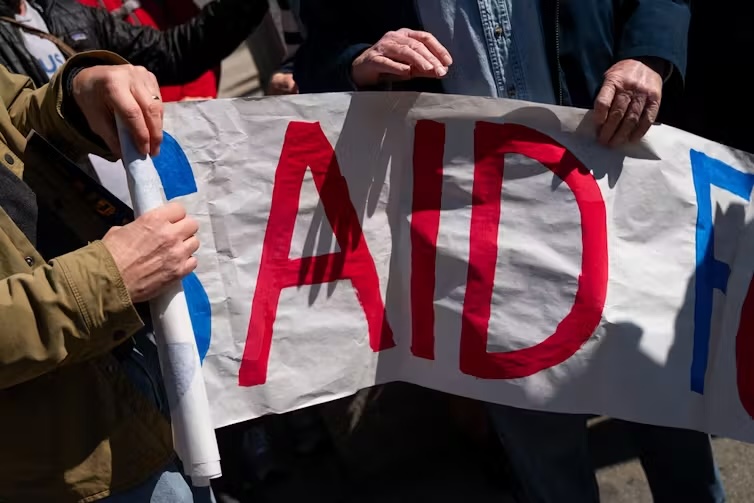 Former USAID staff and supporters rally in protest of the agency’s dismantlement.