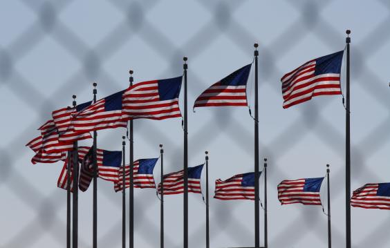 U.S. flags behind a chain-link fence