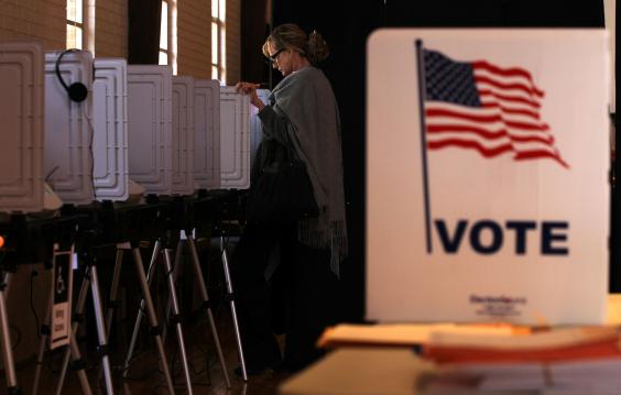 Woman casting her vote at the polls.