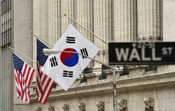 The South Korean flag (R) flies with US flags outside the New York Stock Exchange before South Korea's Ambassador to the US, Ahn Ho-Young rang the opening bell at the NYSE May 13, 2014 in New York.
