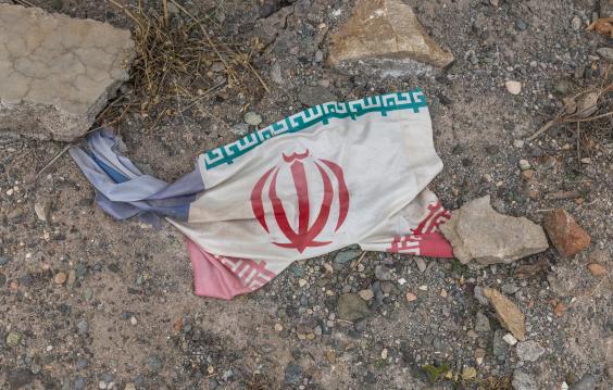 Iranian flag amidst debris