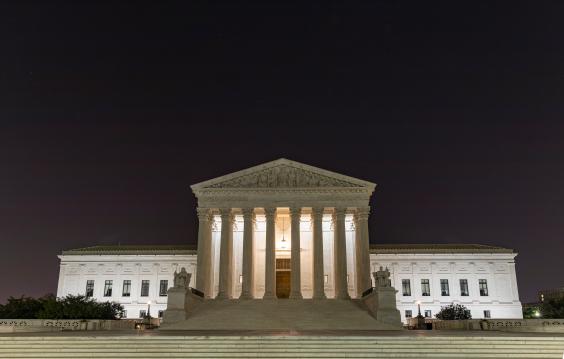 U.S. Supreme Cout Building at night under the crescent moon, Washington D.C.