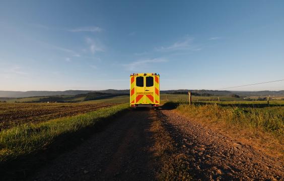 Yellow ambulance on a dirt road: medical transport in rural area