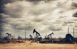 Many oil pumps at work in a field.