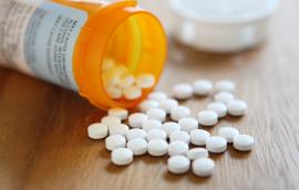 Prescription opioid medication pills spilled onto table
