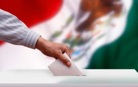 Ballot box in front of the Mexican flag