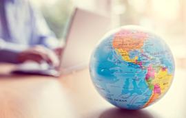 A globe sits on a desk.