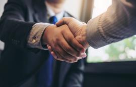 Two business partners shake hands.