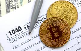 Bitcoins lie on an income tax form.