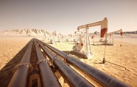 Pump jacks and pipelines move oil through the desert