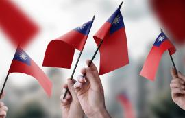  A group of people holding small flags of the Taiwan in their hands