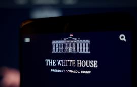 A smartphone screen displays the White House website and the official White House logo.