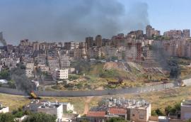 Israel and Palestine divided by wall with smoke and fire pisgat zeev and anata refugees camp, Jerusalem Israel-Aerial view