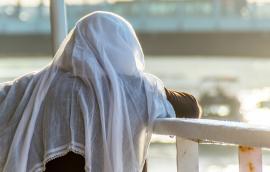  Licensed Find Similar File #:  94934002 Muslim woman on the fence of a boat overlooking the sea at sunset