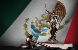 Mexico flag with statue of lady justice, constitution and judge hammer on black drapery. Concept of judgement.