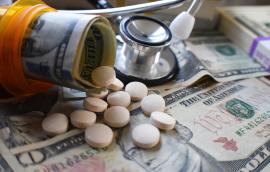 Pill bottle with pills and dollar bill rolls inside