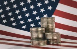 stacks of metal money are on the American flag. Financial system city concept. US coins and American flag 