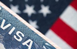VISA to the USA and the flag of the United States of America. work and travel documents for visiting the USA. Visa for immigration.