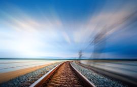 train tracks with motion of fast train visible at right