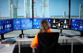 Woman watching oil and gas infrastructure monitors