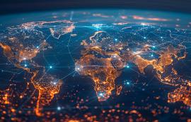 A world map with global network connections on the background of city lights at night.