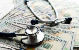 Stethoscope on top of U.S. bills