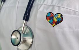 A Doctor Wearing a Stethoscope and a Puzzle Piece Heart Pin.