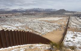 Snowy view of U.S.-Mexico border wall between Ciudad Juárez and El Paso