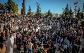 Unrecognizable crowd of ethnic protesters during rally on city street