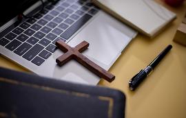  Cross on bible with headset and laptop in online study bible concept.