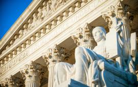  Equal Justice Under Law inscription in the neoclassical columned facade at the entrance to the US Supreme Court building in Washington DC 