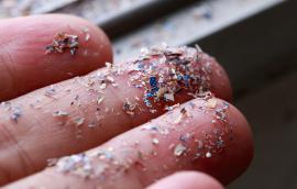 Close up side shot of microplastics lay on hand