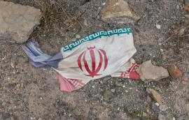 Iranian flag amidst debris