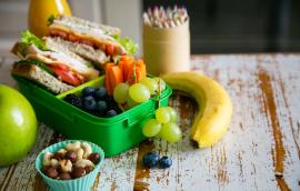 Packed school lunch on kitchen background
