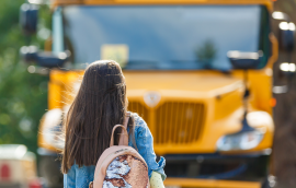 Student walking toward school bus