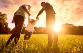 Parents hold the baby's hands