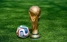  May 7, 2026, United States. The trophy of the 2026 FIFA World Cup and the official Adidas Trionda ball on the green lawn of the stadium. 