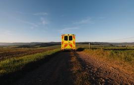 Yellow ambulance on a dirt road: medical transport in rural area