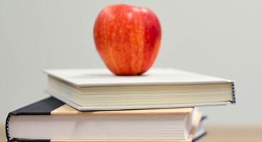 Apple on top of stack of books