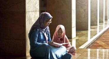 Mother and daughter reading book
