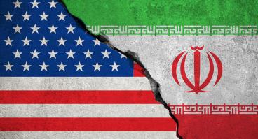 The flags of the U.S. and Iran fusing together as stone.