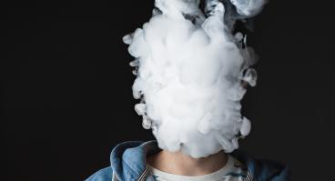 Person blowing out vape smoke