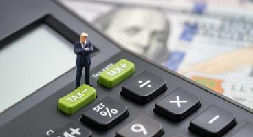 Calculator atop dollar bills