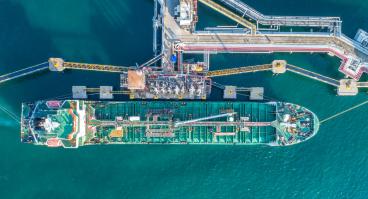 An oil tanker docks at a port.