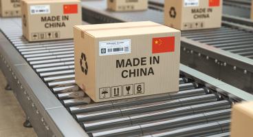 Boxes labeled "MADE IN CHINA" move along a production line.