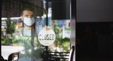 A man closes his business due to the COVID-19 pandemic.