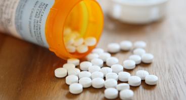 Prescription opioid medication pills spilled onto table