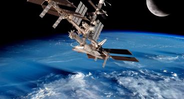 International Space Station with a background of Earth and the moon. 